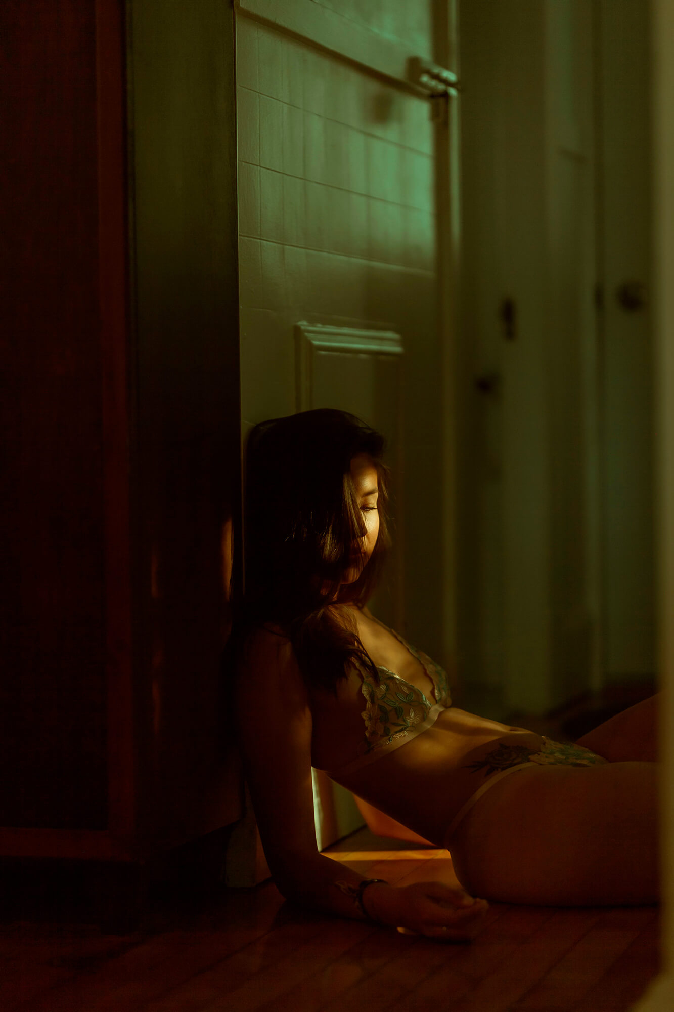 jeune femme photo boudoir assise éclairée par le soleil de sa chambre